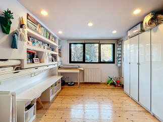 This bright and airy room offers a versatile space, perfect for a home office or creative studio.