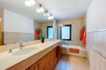 This modern bathroom features a sleek design with a large vanity and ample storage.