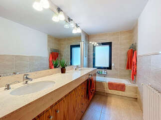 This modern bathroom features a sleek design with a large vanity and ample storage.