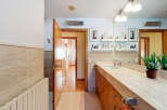 Step into this beautifully designed bathroom, featuring a sleek countertop and stylish wooden cabinetry.