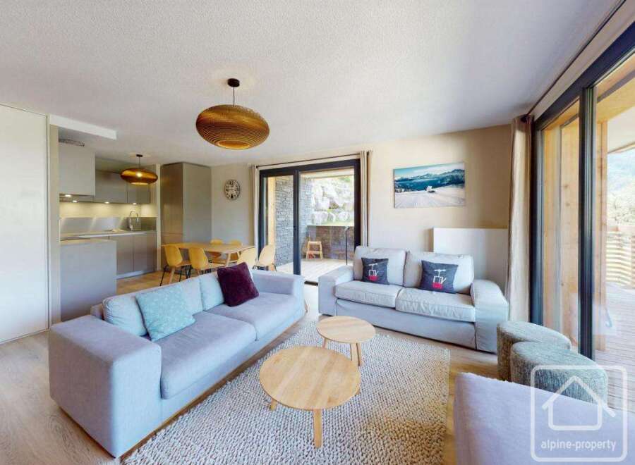 This stunning apartment boasts an open-plan living area with ample natural light, perfect for relaxation.