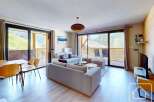 This stunning apartment boasts a spacious open-plan living area with floor-to-ceiling windows offering breathtaking mountain views.