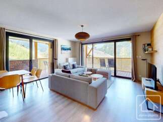 This stunning apartment boasts a spacious open-plan living area with floor-to-ceiling windows offering breathtaking mountain views.