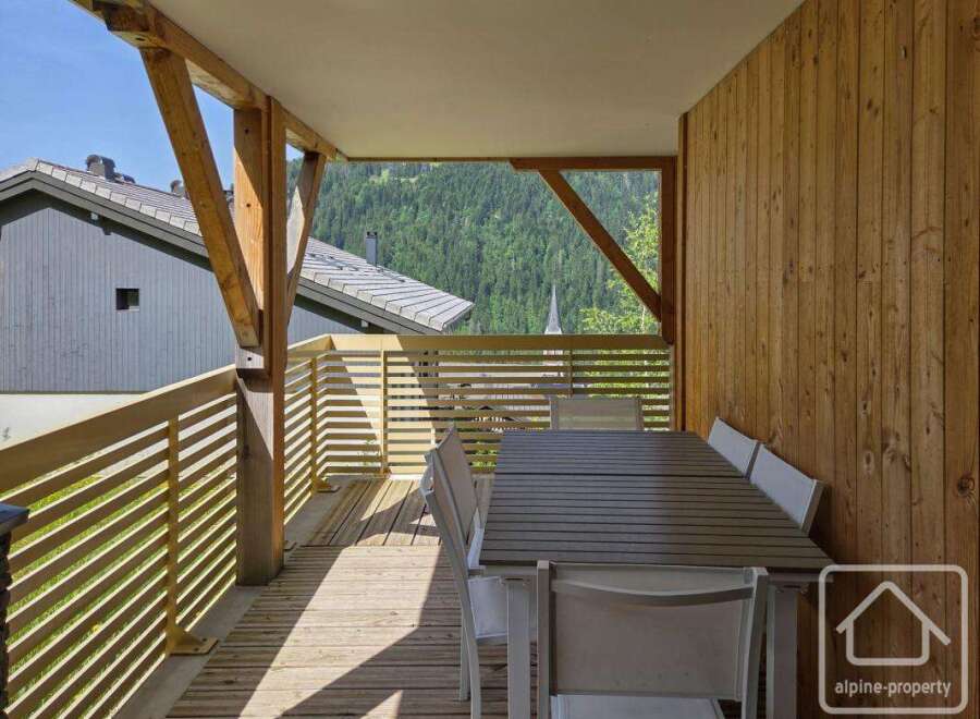 This stunning property boasts a spacious balcony with breathtaking mountain views, perfect for outdoor dining and relaxation.