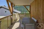 This stunning property boasts a spacious balcony with breathtaking mountain views, perfect for outdoor dining and relaxation.