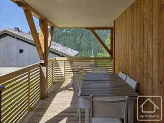 This stunning property boasts a spacious balcony with breathtaking mountain views, perfect for outdoor dining and relaxation.