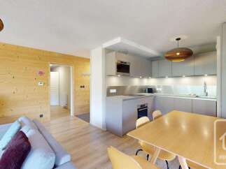 This stunning apartment boasts a modern, open-plan kitchen and living area, perfect for entertaining.