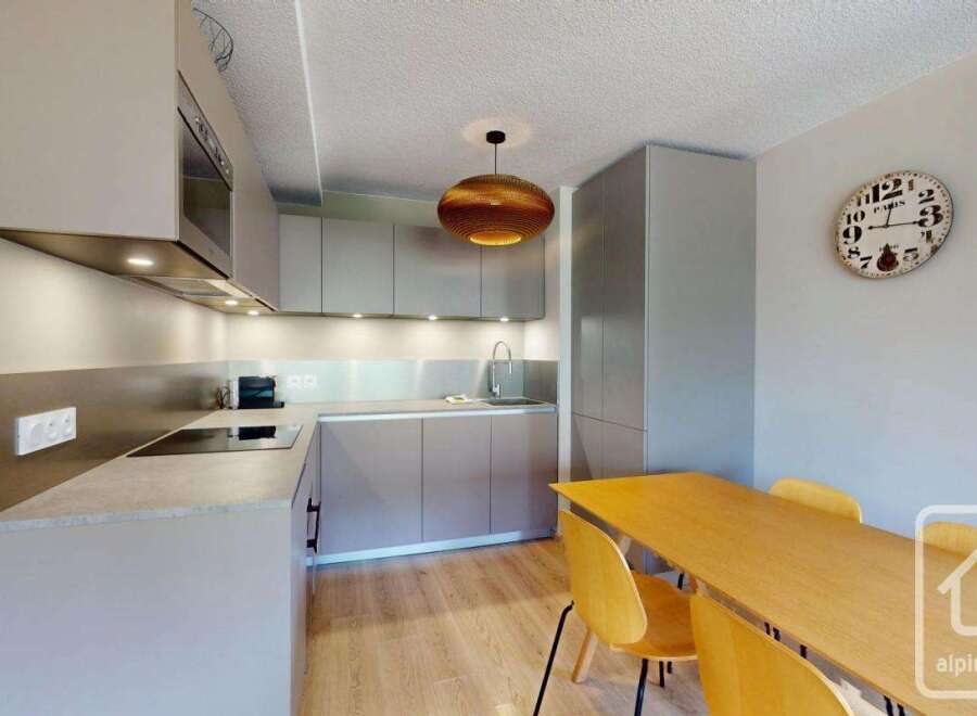 Stylish apartment featuring a modern kitchen with integrated appliances and sleek cabinetry.
