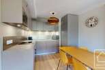 Stylish apartment featuring a modern kitchen with integrated appliances and sleek cabinetry.