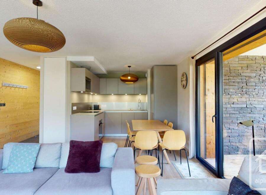This stunning apartment boasts an open-plan living area with a modern kitchen and dining space, perfect for entertaining.