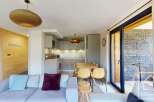 This stunning apartment boasts an open-plan living area with a modern kitchen and dining space, perfect for entertaining.