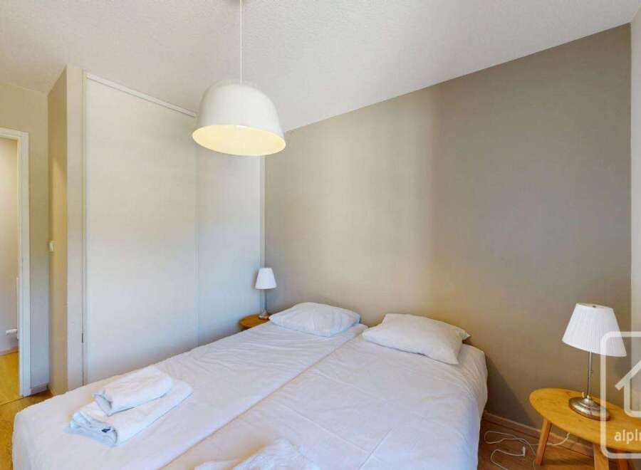Cozy bedroom with double bed, built-in wardrobe, and bedside table.