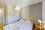 Cozy bedroom with double bed, built-in wardrobe, and bedside table.