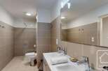 Modern bathroom with double sinks, a walk-in shower, and stylish tile.
