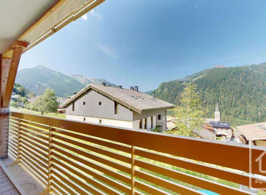 This stunning property boasts a spacious balcony with breathtaking mountain views.