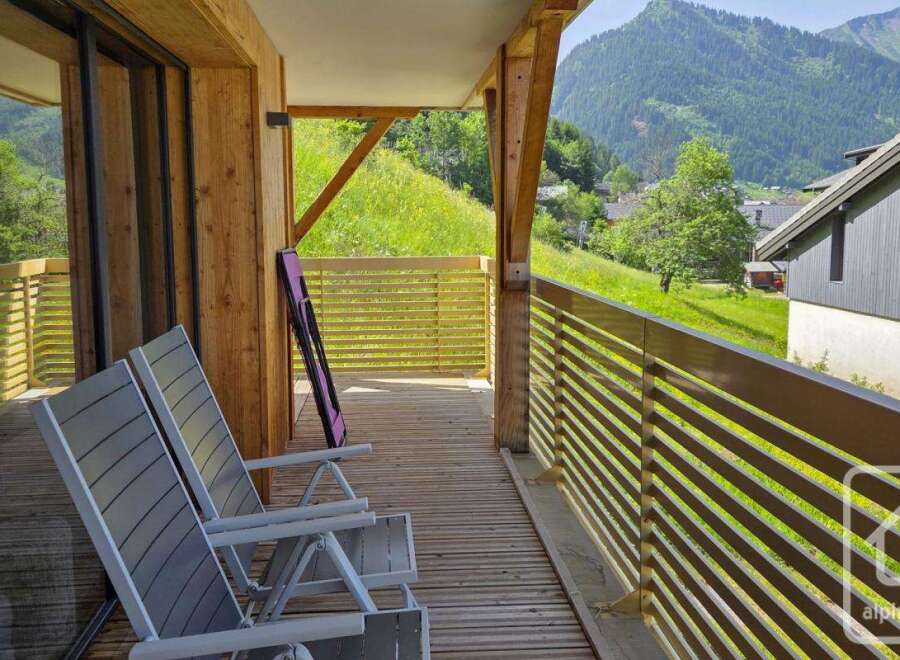 This stunning property boasts a spacious balcony with breathtaking mountain views.