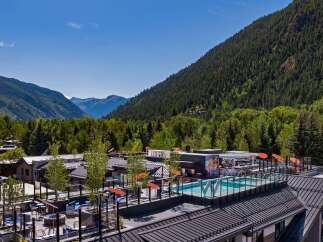 Luxury rooftop pool and lounge with mountain views.