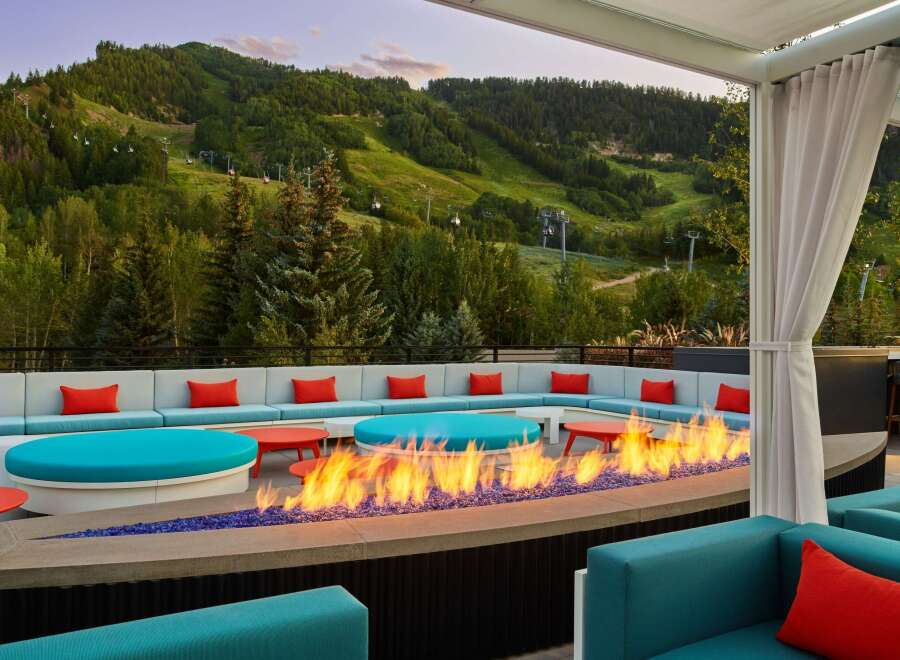Cozy up by the fire pit on our rooftop terrace, taking in breathtaking mountain views.
