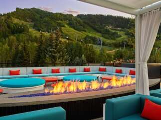 Cozy up by the fire pit on our rooftop terrace, taking in breathtaking mountain views.