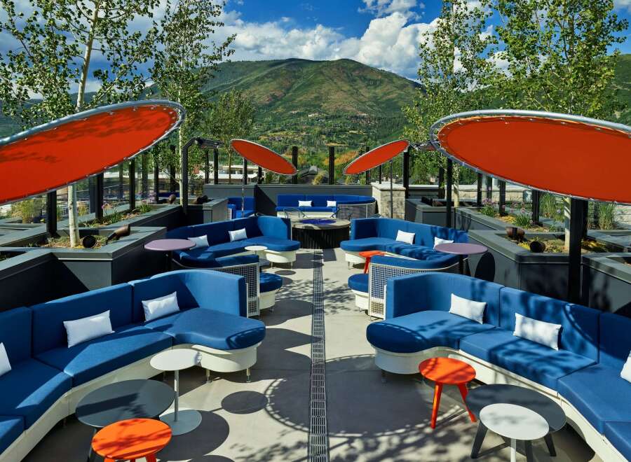 Relax and soak up the sun on our rooftop terrace, complete with comfortable seating, fire pits, and stunning mountain views.