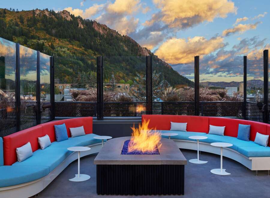 Cozy up by the fire pit on this rooftop lounge, complete with stunning mountain views and comfortable seating.