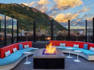 Cozy up by the fire pit on this rooftop lounge, complete with stunning mountain views and comfortable seating.