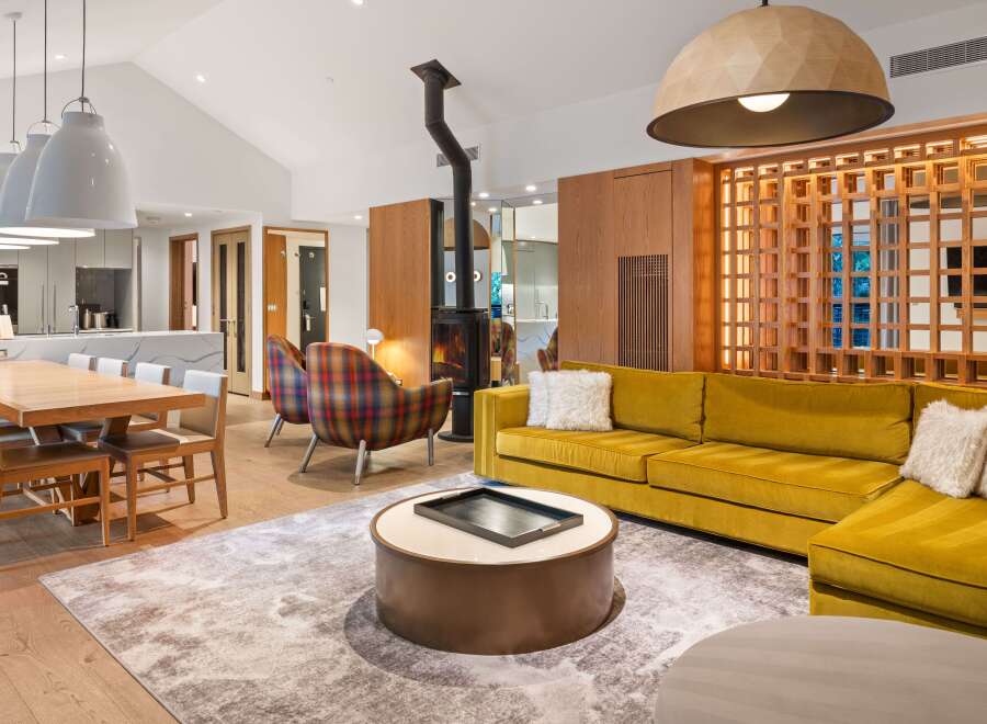 This stunning living space boasts a modern design with a cozy fireplace, perfect for relaxing evenings.
