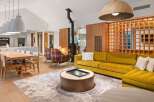 This stunning living space boasts a modern design with a cozy fireplace, perfect for relaxing evenings.