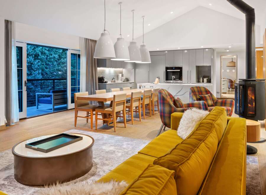 Experience luxury living in this stunning property, featuring a modern kitchen and a cozy living area.