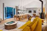 Experience luxury living in this stunning property, featuring a modern kitchen and a cozy living area.