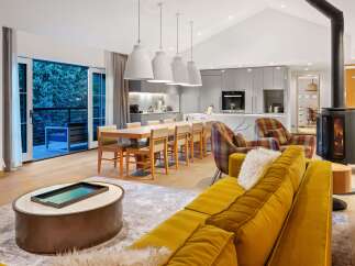 Experience luxury living in this stunning property, featuring a modern kitchen and a cozy living area.