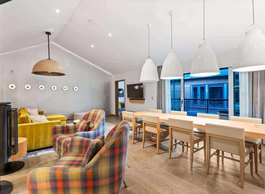 Experience luxury living in this stunning property, featuring a spacious living area with a cozy fireplace and stylish seating.