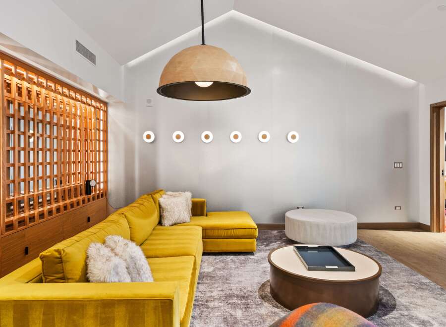 This stunning living space boasts a modern design with a pop of color.