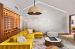 This stunning living space boasts a modern design with a pop of color.