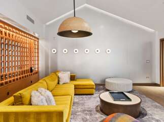 This stunning living space boasts a modern design with a pop of color.