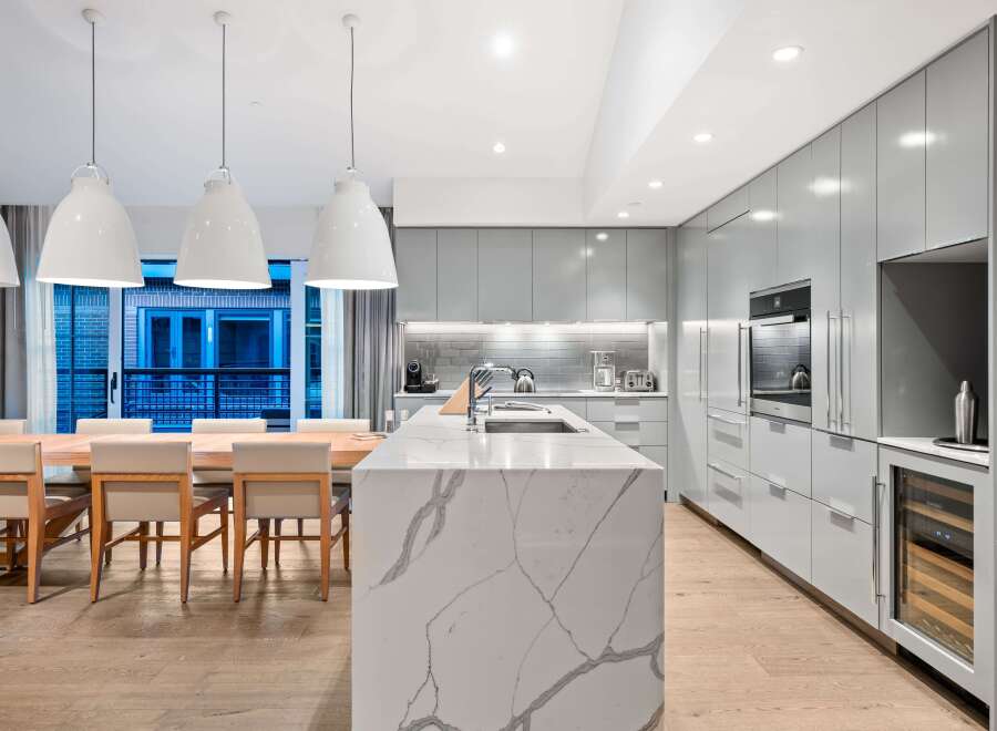 Modern kitchen design with a large island and sleek cabinetry.
