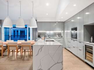 Modern kitchen design with a large island and sleek cabinetry.