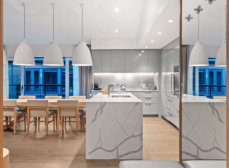 Modern kitchen design with a large island and sleek cabinetry.