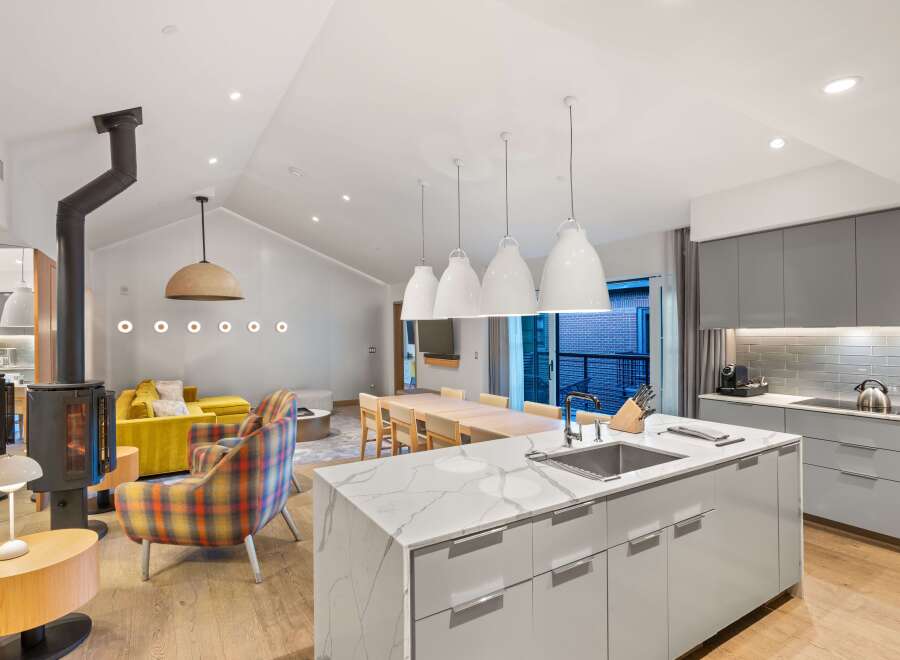 This stunning modern kitchen boasts a sleek design with a large island, perfect for culinary creations and entertaining.
