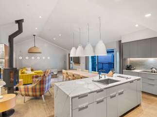 This stunning modern kitchen boasts a sleek design with a large island, perfect for culinary creations and entertaining.