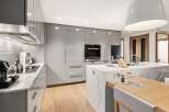 Modern kitchen design with sleek gray cabinetry and a stunning marble island.