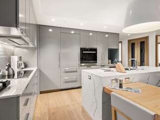 Modern kitchen design with sleek gray cabinetry and a stunning marble island.