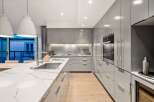 Modern kitchen design with sleek gray cabinetry and a stunning marble countertop.