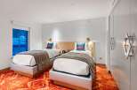 Experience modern comfort in this stylish hotel room featuring two cozy beds.