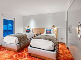 Experience modern comfort in this stylish hotel room featuring two cozy beds.
