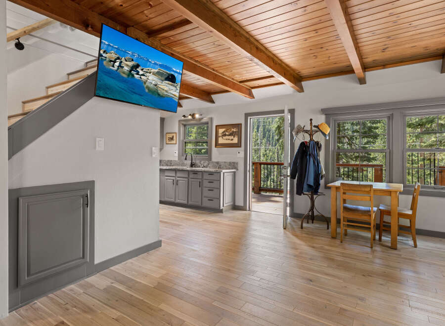 This stunning cabin boasts a beautiful wood-beamed ceiling and hardwood floors throughout.