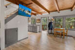 This stunning cabin boasts a beautiful wood-beamed ceiling and hardwood floors throughout.