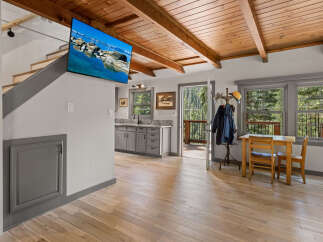This stunning cabin boasts a beautiful wood-beamed ceiling and hardwood floors throughout.