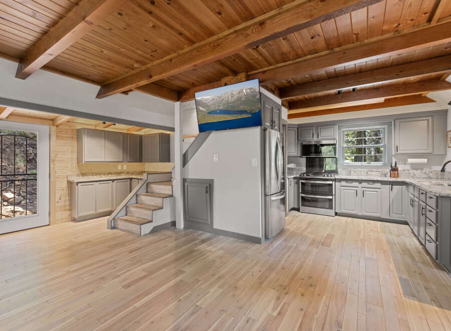 This stunning cabin boasts a spacious open-concept kitchen and living area, perfect for entertaining.