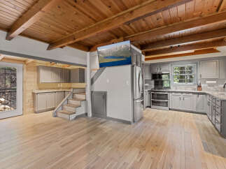 This stunning cabin boasts a spacious open-concept kitchen and living area, perfect for entertaining.